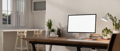 Home workspace features a computer mockup on a wooden table in a contemporary bright room. photo