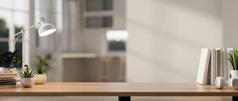 A copy space for displaying products on a wooden working table in a modern white room. photo