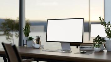 A computer desk in a modern office surrounded by large windows with a lake view, a computer mockup photo