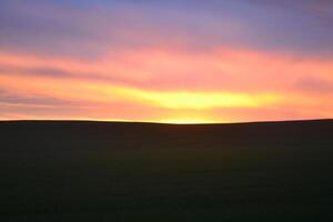 Photo of a sunset in the field.