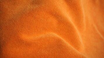 Detail of orange towel fabric texture background with copy space. photo
