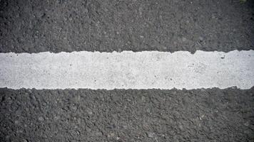 White line on the asphalt road. Abstract background or texture for design. photo
