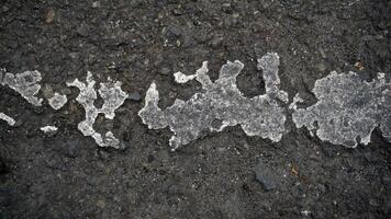 Asphalt texture with cracks and scratches. Abstract background for design. photo