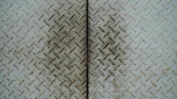 Old rusty metal sheet with rhombus pattern, construction industry background. photo