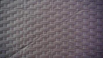 Brick wall texture background. Brown flat pattern of synthetic rattan material made from plastic. photo