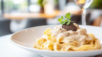 Delicious creamy pasta topped with truffle and herbs, perfect for gourmet dining and culinary delights. photo