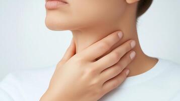 A close-up of a woman gently touching her neck, symbolizing health and well-being in a serene and modern setting. photo