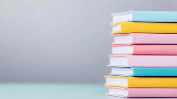 A vibrant stack of colorful books arranged neatly on a minimalist surface, perfect for education and creativity themes. photo