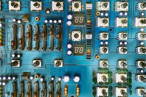 Electronic printed circuit board with with potentiometers and radio components photo