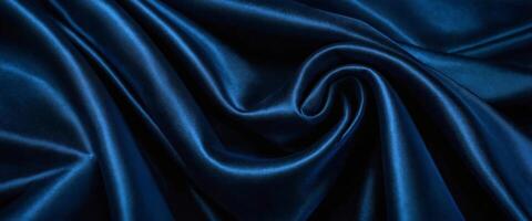 Beautiful dark blue silk satin background with soft folds on shiny fabric, luxury background with space for design, web banner, flat lay, top view. photo