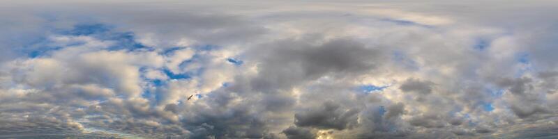 Dark blue sunset sky panorama with Cumulus clouds. Seamless hdr pano in spherical equirectangular format. Complete zenith for 3D visualization, game and sky replacement for aerial drone 360 panoramas. photo