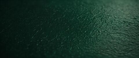 A green paper texture background offers an abstract dark green surface suitable for various design projects. photo