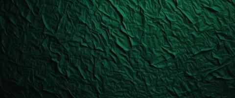 A green paper texture background offers an abstract dark green surface suitable for various design projects. photo