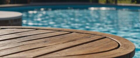 A round wooden table with a blurred background of an empty swimming pool outdoors on a bright summer day. photo