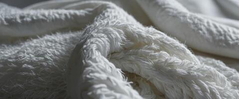 A texture of a white towel suitable for backgrounds This fabric or textile is made of cotton fiber material, giving it a plush, fluffy, dry, soft, and clean appearance. photo