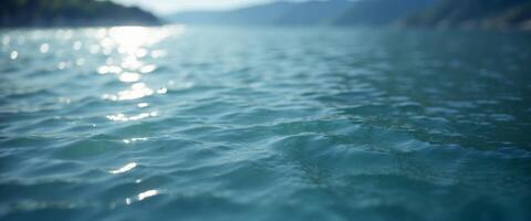 Beautiful background image in form of texture water surface, beautiful light reflections glare in light blue colors. photo