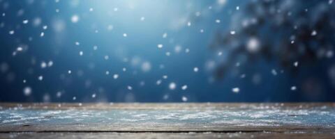 Beautiful winter snowy blurred defocused blue background and empty wooden flooring Flakes of snow fall and sparkle on light, copy space. photo