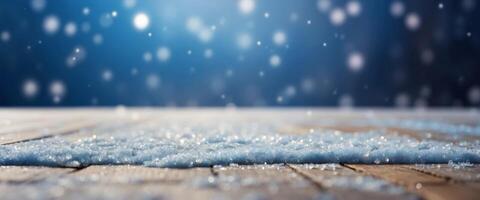Beautiful winter snowy blurred defocused blue background and empty wooden flooring Flakes of snow fall and sparkle on light, copy space. photo