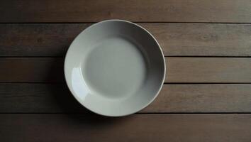 Empty ceramic shape plate for food on the table top view Copy space template for your text. photo