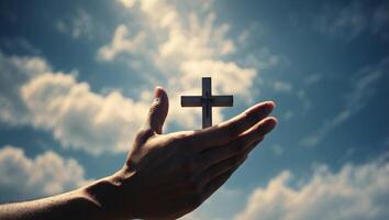 Hands with cross on sky background Christian symbols The cross in the sky. photo