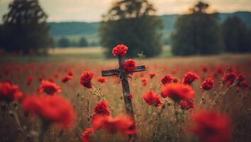 Cross with red flowers in the field, retro toned image. photo