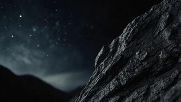 Vertical image of a black rock on a black background. photo