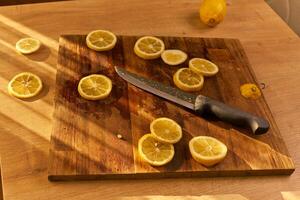 Slices of organic lemon on a wooden cutting board photo