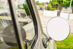 Close-up of a round mirror in a silver retro car with a place for a signature on the mirror. Concept of love for luxury, old money style with a mockup. photo