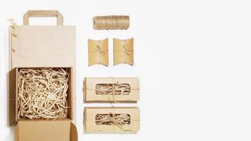 Cardboard boxes with shredded paper inside, paper bag with copy space photo
