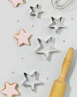 Cookies covered with glaze, cookie cutters, a dough gurney photo