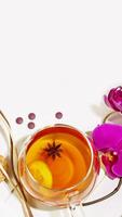 Fruit tea with lemon slice, aroma sticks and orchids with copy space photo