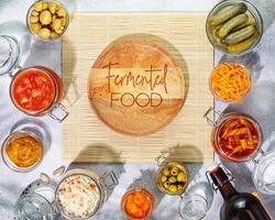 Fermented products vegetables, mushrooms in glass jars, bottle with beer photo