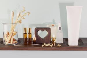 Bio toothpaste, toothbrushes in a glass jar on a wooden board photo