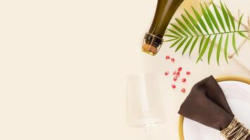 Holiday background with present, table settings and bottle of champagne photo