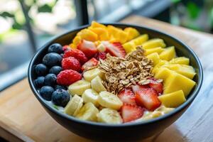 A vibrant assortment of freshly sliced fruits, including bananas, berries, and mango, topped with crunchy granola in a cozy setting. photo