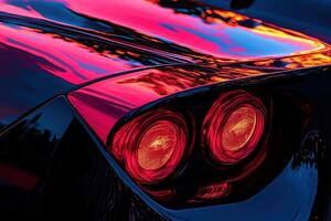 A luxury cars rear tail light glows with striking red hues, reflecting the colorful sunset and surrounding scenery. photo