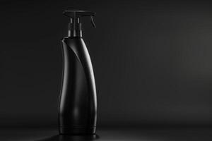 A black shampoo bottle with a pump top sits on a black surface against a black background. The bottle is tall and slender, with a curved shape. The pump top is silver and has a black nozzle. photo