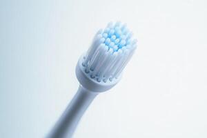 A sleek electric toothbrush stands isolated, emphasizing its modern design and advanced features in a soft, minimalist setting. photo
