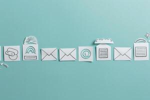 Artistic arrangement of unique CRM icons and symbols, crafted from paper, displayed against a calming solid background. photo
