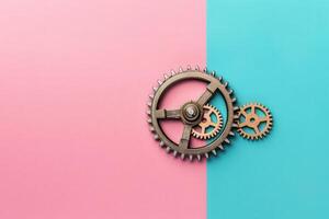 A set of metallic gears rests elegantly on a split pink and blue backdrop, representing the concept of automation and efficiency in modern business. photo