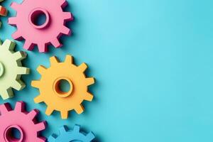 Vibrantly colored gears are creatively displayed on a smooth blue surface, representing the concept of automation and productivity. photo