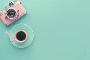 A vintage camera rests beside a delicate cup of coffee, symbolizing the perfect blend of creativity and relaxation in a serene setting. photo