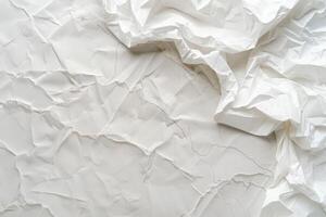 A wrinkled white sheet of paper spreads across a plain surface, showcasing unique textures and creases. photo