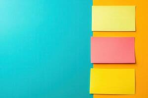 A dynamic brainstorming session unfolds as colorful notes in bright yellow, pink, and orange are arranged on a striking turquoise surface. photo