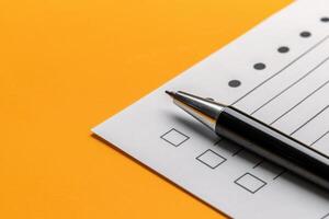 A neatly arranged feedback form sits on a cheerful yellow surface, accompanied by a sleek pen, inviting responses and engagement from users. photo