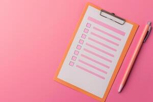 A clipboard holds a neatly arranged customer feedback form, accompanied by a pink pen, creating an inviting atmosphere for responses. photo