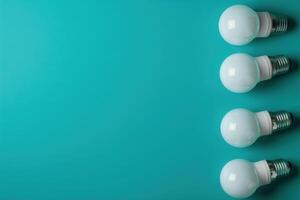 Four energy-efficient light bulbs are arranged neatly on a vibrant teal background, showcasing eco-friendly design for savings. photo