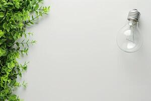 A lightbulb rests beside vibrant greenery on a clean background, emphasizing energy conservation ideas and a fresh atmosphere. photo