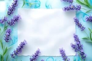 White Paper Surrounded by Purple Lavender Blossoms on a Light Blue Background photo