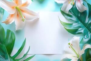 White Lilies and Green Leaves with Blank White Paper photo